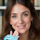 Emma Lawson holding a book club badge